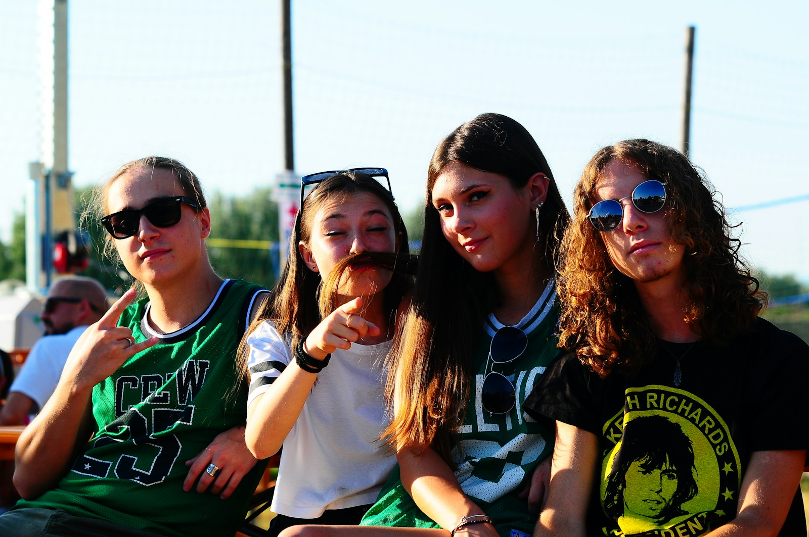 A group of young people sitting next to each other